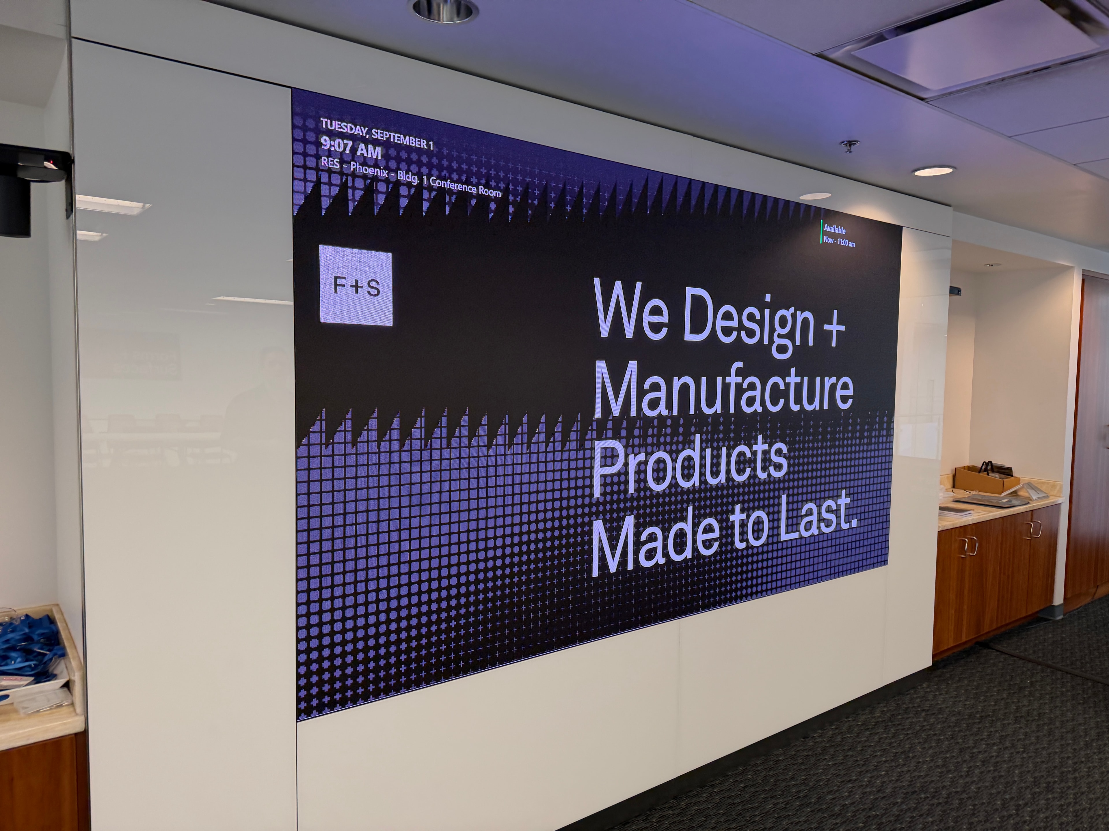 Angled view of Vivid 1.2mm LED display in Forms + Surfaces conference room