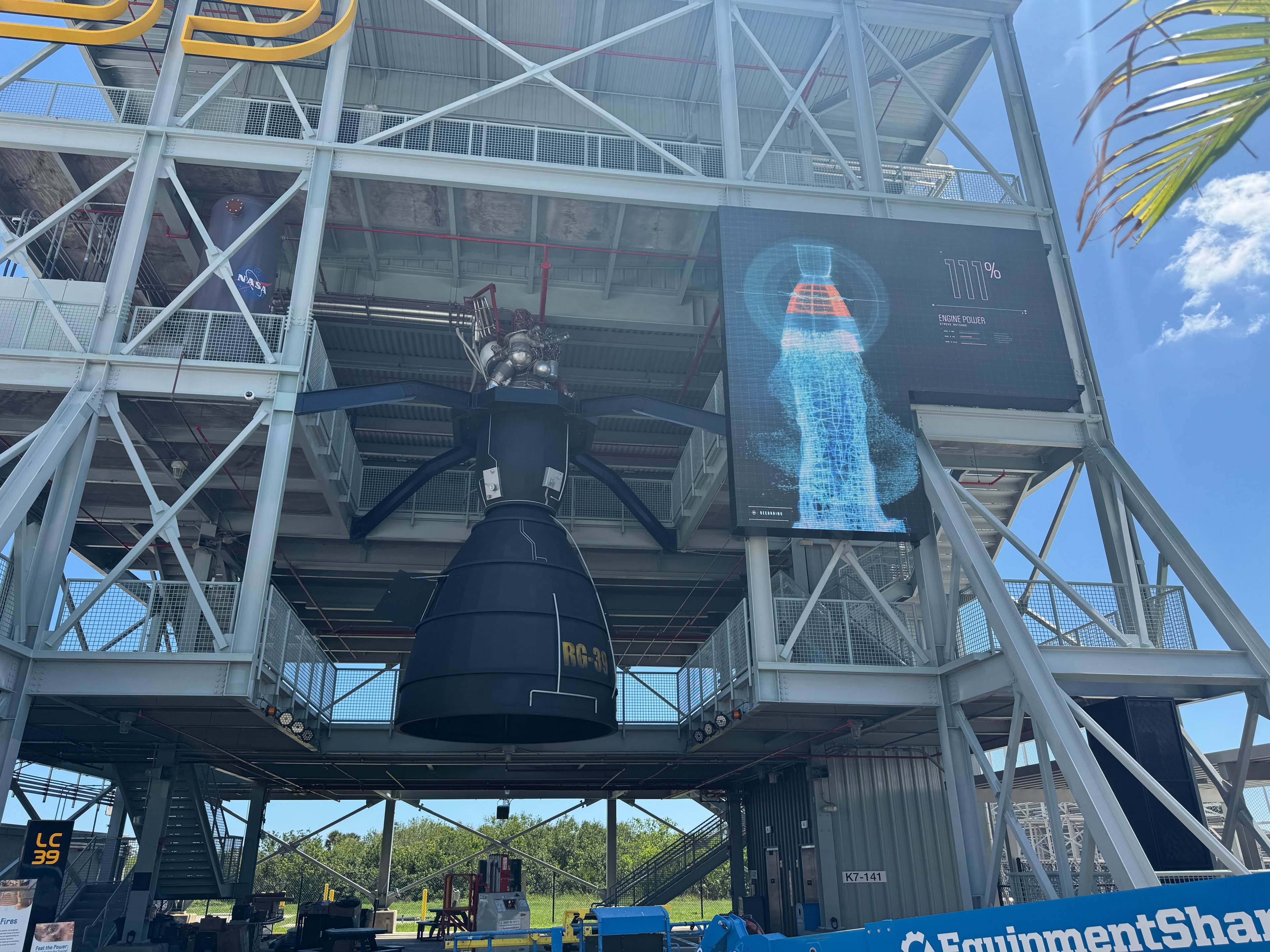 Kennedy Space Center LC39 gantry outdoor LED display showing NASA engine power telemetry graphic alongside RG-30 rocket engine